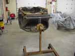 Photo shows a 1954 VW Cabriolet on a rotisserie for restoration
