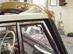 Close-up shot of the restored frame and new wood header beam on a 1954 Volkswagen convertible bug