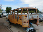 Volkswagen junkyard with bullet riddled 23 Window Deluxe Bus